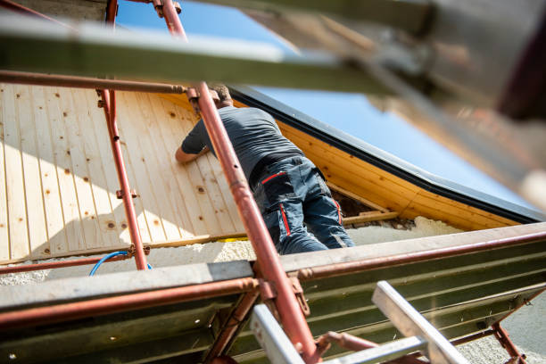 construction worker installing wooden planks on house facade construction worker installing wooden planks on house facade